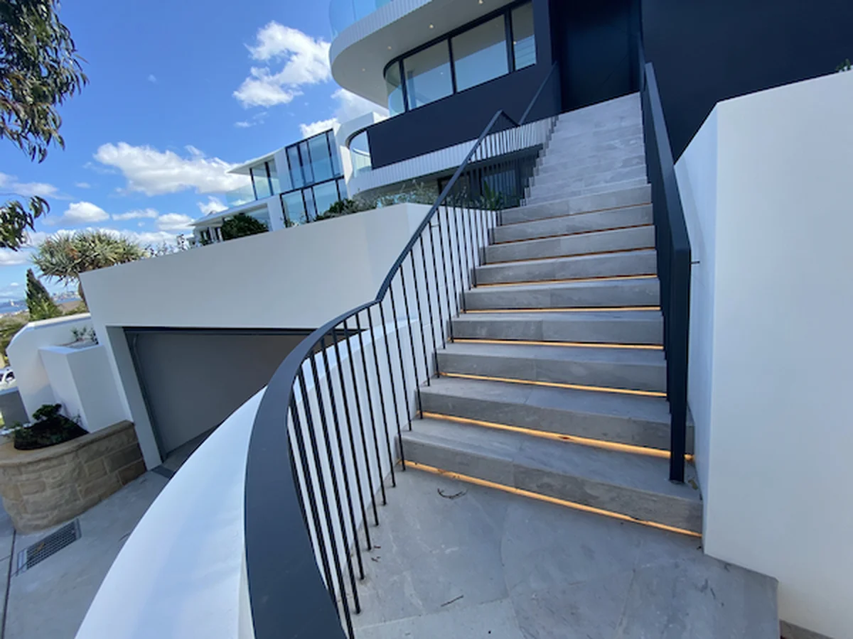 Custom steel balustrade with modern curved design and integrated lighting at Dover Heights Eastern Suburbs Sydney - architectural metalwork by A&E Metal Craft